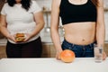 Obese woman with burger and dietitian with fruits Royalty Free Stock Photo