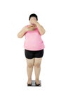 Obese woman standing on the weighing scale Royalty Free Stock Photo