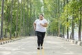 Obese woman jogging on the road Royalty Free Stock Photo