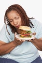 Obese Woman Looking At Burger