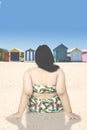 Obese woman sits on seashore Royalty Free Stock Photo