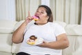 Obese woman enjoying a plate of tasty donuts