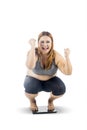 Obese woman squat down on the weight scales Royalty Free Stock Photo