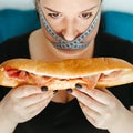 Obese woman with unhealthy food, eating disorder Royalty Free Stock Photo