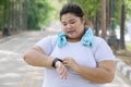 Obese woman wearing her smartwatch on the road Royalty Free Stock Photo