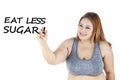 Obese woman writes eat less sugar word