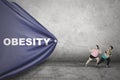 Obese women pulling Obesity text Royalty Free Stock Photo