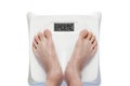 Obesity Epidemic Concept With Feet on Bathroom Scale Isolated on White Background Royalty Free Stock Photo