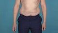 Man jumps, fat folds and overweight on the abdomen shaking in slow motion. Obesity, graceless body. Plump or thick guy