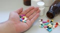 Obesity patient take medicine colorful tablets, pills and capsules in hand for treatment and cure disease or sickness. Royalty Free Stock Photo