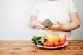 Fat woman snacking with fruits and vegetables Royalty Free Stock Photo