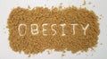 Obesity Spelled Out in Brown Sugar on White Background Royalty Free Stock Photo