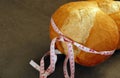 Obesity and whole wheat bread, tape measure wrapped in a large bread