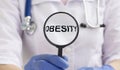 Obesity Word through magnifying glass in hands of doctor, medical concept