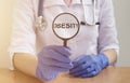 Obesity Word through magnifying lens glass, medical concept