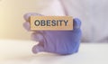 Obesity Word on wooden block, medical concept