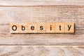 Obesity word written on wood block. Obesity text on wooden table for your desing, concept