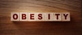 Obesity word written on wood block on wooden table..Healthy eating habits concept Royalty Free Stock Photo