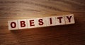 Obesity word written on wood block on wooden table..Healthy eating habits concept Royalty Free Stock Photo