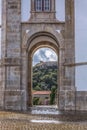 View of the castle and fortress of obidos, between arches pillars of Lord Jesus of the Stone Sanctuary Royalty Free Stock Photo