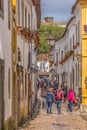 View of a portuguese street with buildings and tourist people, on Portuguese medieval village of Ãâbidos, in Portugal