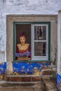 View of street shop with a weird mannequin on window Royalty Free Stock Photo