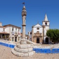 Obidos, Portugal. Medieval Town Pillory and Santa Maria Church seen from Direita Street Royalty Free Stock Photo