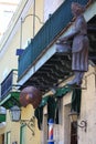 Obispo street. View along the building with balconies, signboards and lanterns