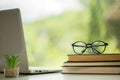 Object education green nature background with stack of ancient books or old bible, open paper book on wooden table with copy space Royalty Free Stock Photo