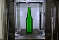 Object green bottle printed on 3D printer close-up, on desktop of 3d printer. Royalty Free Stock Photo