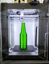 Object green bottle printed on 3D printer close-up, inside on 3d printer. Royalty Free Stock Photo