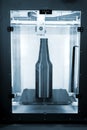 Object green bottle printed on 3D printer close-up, inside on 3d printer. Royalty Free Stock Photo