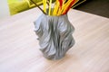 The object vase printed on the 3d printer stands on the table