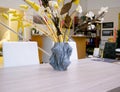 The object vase printed on the 3d printer stands on the table