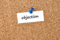 Objection. Word written on a piece of paper, cork board background