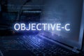 Objective-C inscription against laptop and code background. Learn programming language, computer courses, training Royalty Free Stock Photo