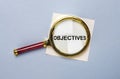 Objectives word on paper through magnifying lens