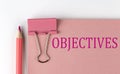 OBJECTIVES word on the pink paper with pink pencil