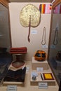 Objects and attire for buddhist monks exposed in museum. Alms bowl, hand fan, lectern, tea cup and filter, razor to shave head,