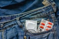 Medical pills for sexual health and one condom in your jeans pocket Royalty Free Stock Photo