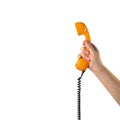 Objects Hands action - Hand holds retro orange phone red handset. Isolated Royalty Free Stock Photo