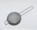 objects: Strainer Tea Orange Drink made of stainless, on white background. Royalty Free Stock Photo
