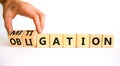 Obligation and mitigation symbol. Businessman turns wooden cubes changes the concept word obligation to mitigation. Beautiful