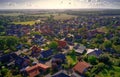 Oblique aerial view of a village in Germany with detached houses, yarns, lawns and roads