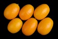 Oblique Oval Kumquats On Black Background