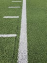 Oblique view green turf painted with white line marked by distances