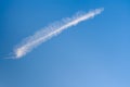 Oblong white cloud like a bird feather on blue sky background.