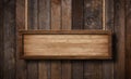 Oblong wooden sign hanging on ropes with wood planks background