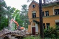 Obninsk, Russia - July 2018: Demolition with an excavator of an old brick building in Obninsk