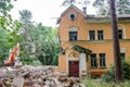 Obninsk, Russia - July 2018: Demolition with an excavator of an old brick building in Obninsk